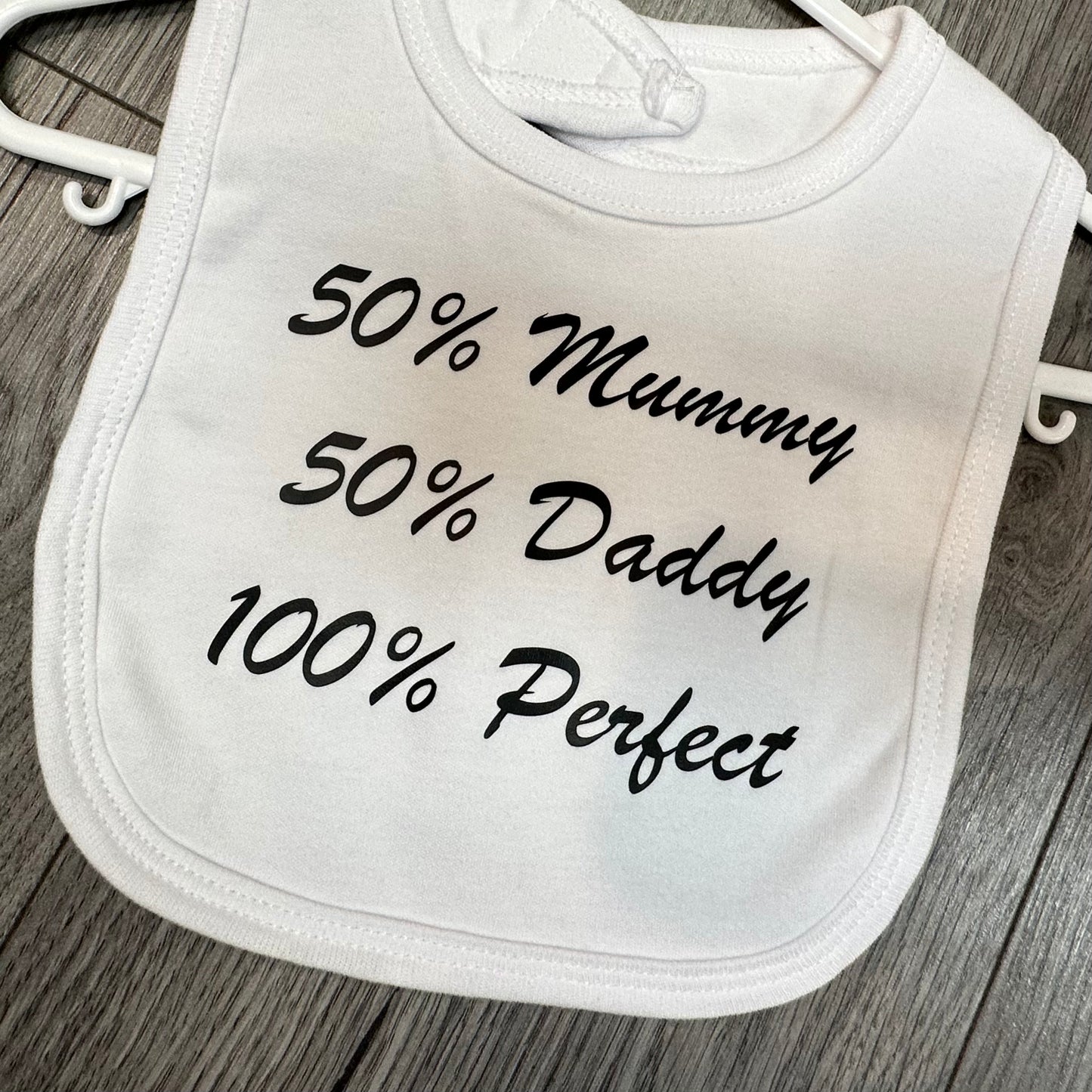 ''50% Mummy, 50% Daddy, 100% perfect'' slogan white baby bib