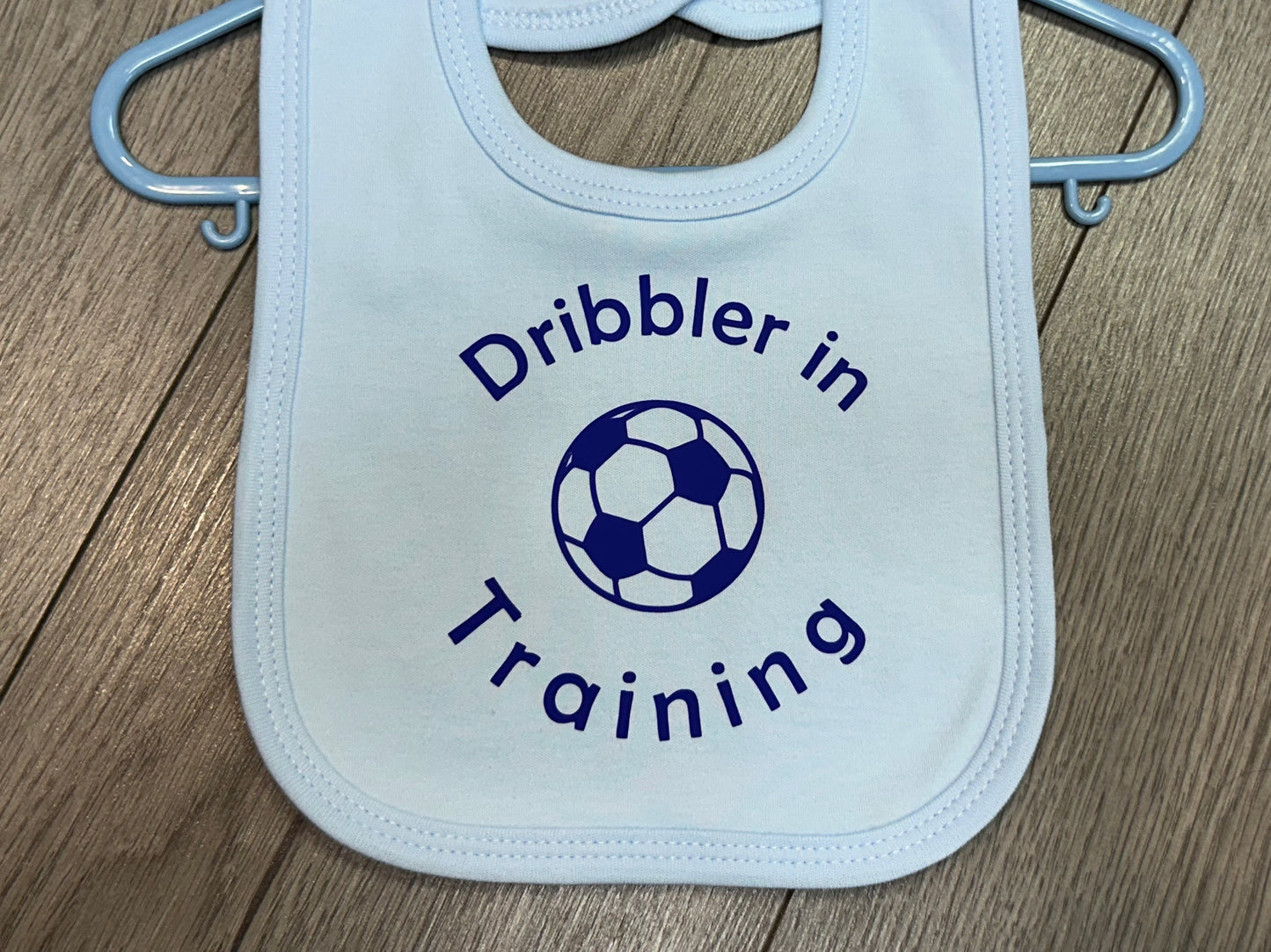 'Dribbler in training'' slogan blue baby bib