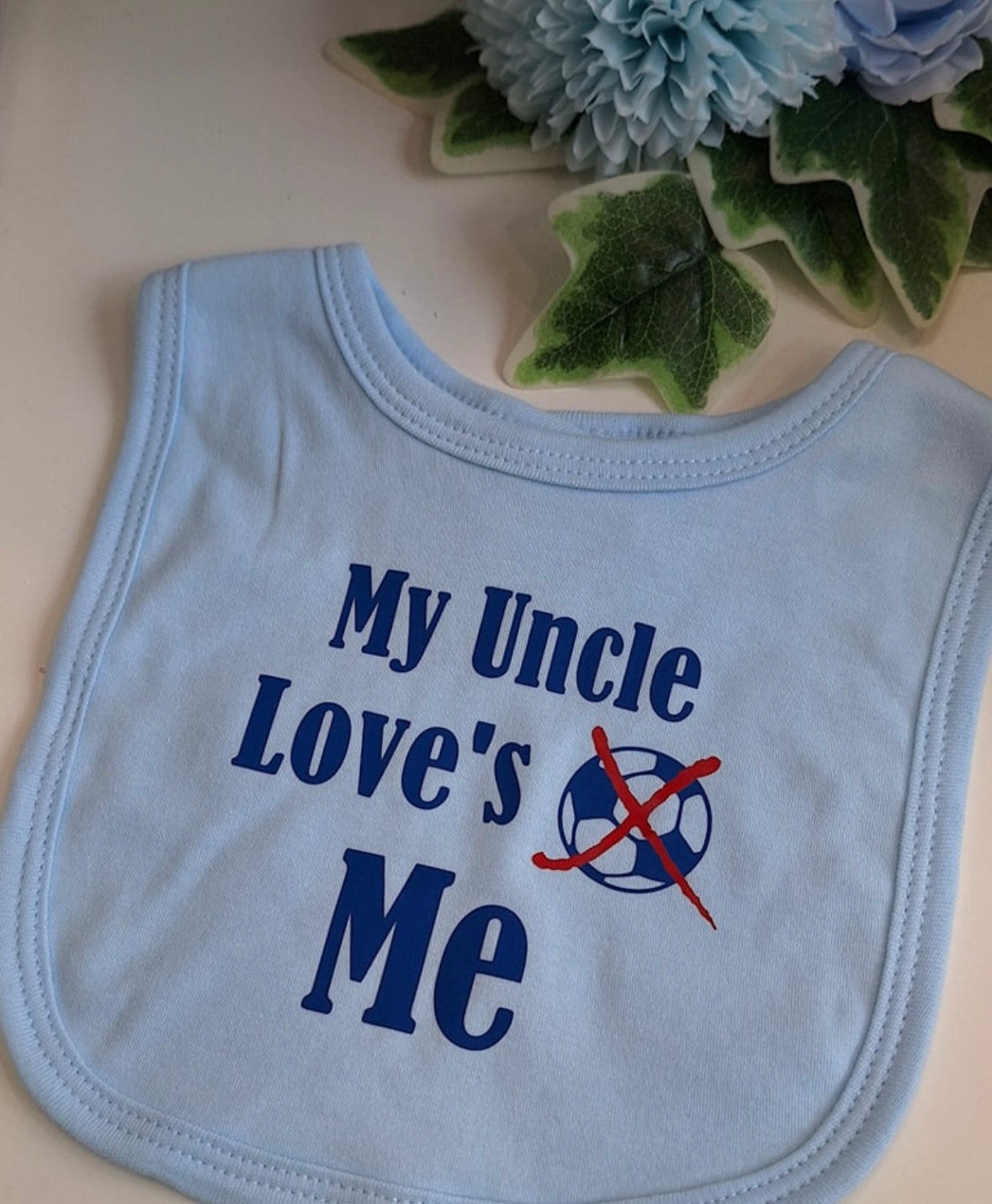 'My Uncle Loves Me'' slogan blue baby bib